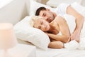 Happy couple sleeping in bed at home Royalty Free Stock Photo