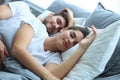 Happy couple sleeping in a comfortable bed at home. Royalty Free Stock Photo