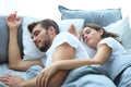 Happy couple sleeping in a comfortable bed at home. Royalty Free Stock Photo