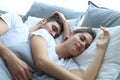 Happy couple sleeping in a comfortable bed at home. Royalty Free Stock Photo