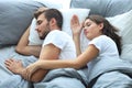 Happy couple sleeping in a comfortable bed at home. Royalty Free Stock Photo