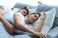 Happy couple sleeping in a comfortable bed at home. Royalty Free Stock Photo