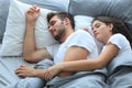 Happy couple sleeping in a comfortable bed at home. Royalty Free Stock Photo