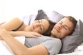 Happy couple sleeping together on a bed Royalty Free Stock Photo