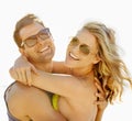 Happy, couple and smile with hug by beach with sunglasses, vacation and holiday for memories or honeymoon. Woman, man Royalty Free Stock Photo