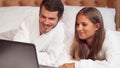 Happy couple smiling to the camera at their honeymoon suite Royalty Free Stock Photo