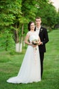 Happy couple smilinging happily on their wedding day in a green garden Royalty Free Stock Photo