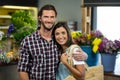 Happy couple standing in the florist shop Royalty Free Stock Photo