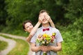 Happy couple standing in green park, kissing, smiling, laughing Royalty Free Stock Photo