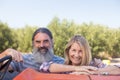 Happy couple standing near tractor in olive farm Royalty Free Stock Photo