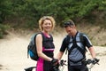 Happy couple standing outdoors with bikes Royalty Free Stock Photo