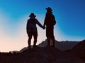 Happy couple standing together on the peak of mountain Royalty Free Stock Photo