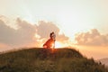 Happy couple stands in embrace and kisses each other on beautiful sunset in mountain. Royalty Free Stock Photo