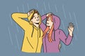 Happy couple stands in rain in hoods and hugs rejoicing at cloudy weather and autumn downpour Royalty Free Stock Photo