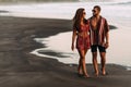 Happy couple strolling along a sandy beach. Couple in love at sunset by the sea. Couple in love on vacation. Romantic couple Royalty Free Stock Photo