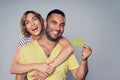 Happy couple in studio laughing over grey Royalty Free Stock Photo