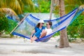 Happy couple on summer vacation relaxing in hammock Royalty Free Stock Photo