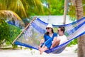 Happy couple on summer vacation relaxing in hammock Royalty Free Stock Photo