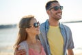 Happy couple in sunglasses hugging on summer beach Royalty Free Stock Photo