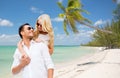 Happy couple in sunglasses over summer beach Royalty Free Stock Photo