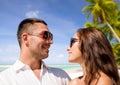 Happy couple in sunglasses over tropical beach Royalty Free Stock Photo