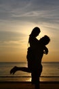 Happy Couple on Sunset Beach - Silhouette Royalty Free Stock Photo