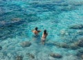 Happy couple swimming in the transparent turquoise sea