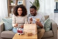 Happy couple with takeaway food and drinks at home Royalty Free Stock Photo