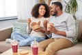 Happy couple with takeaway food and drinks at home Royalty Free Stock Photo