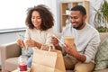Happy couple with takeaway food and drinks at home Royalty Free Stock Photo