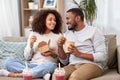 Happy couple with takeaway food and drinks at home Royalty Free Stock Photo