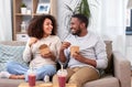 Happy couple with takeaway food and drinks at home Royalty Free Stock Photo