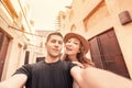 Happy couple takes a selfie against the backdrop of ancient Arabic architecture in the old town of Dubai. Honeymoon journey