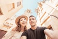 happy couple takes a selfie against the backdrop of ancient Arabic architecture in the old town of Dubai. Honeymoon journey