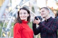 Happy couple taking photos of each other outdoors Royalty Free Stock Photo