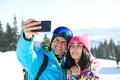 Happy couple taking selfie in mountains. Winter vacation Royalty Free Stock Photo