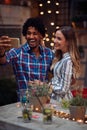 Happy couple taking a selfie at the open air birthday party. Quality friendship time together Royalty Free Stock Photo