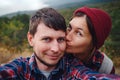 Happy couple taking selfie self-portrait photo hiking.