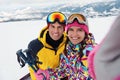 Happy couple taking selfie at ski resort. Winter vacation Royalty Free Stock Photo