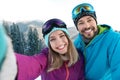 Happy couple taking selfie during winter vacation Royalty Free Stock Photo