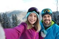 Happy couple taking selfie during winter vacation Royalty Free Stock Photo