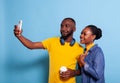 Happy couple taking selfies on smartphone in studio Royalty Free Stock Photo