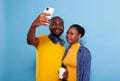 Happy couple taking selfies on smartphone in studio Royalty Free Stock Photo