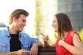 Happy couple talking sitting on a bench in a park Royalty Free Stock Photo