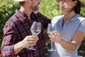 happy couple tasting white wine in vineyard Royalty Free Stock Photo