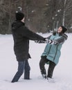 Happy couple of teenagers dancing and having fun in snow in winter Royalty Free Stock Photo