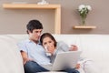 Happy couple with their laptop on the sofa Royalty Free Stock Photo