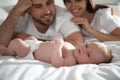 Happy couple with their newborn baby on bed Royalty Free Stock Photo