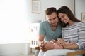 Happy couple with their newborn baby at home. Space for text Royalty Free Stock Photo