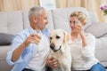 Happy couple with their pet dog drinking champagne Royalty Free Stock Photo